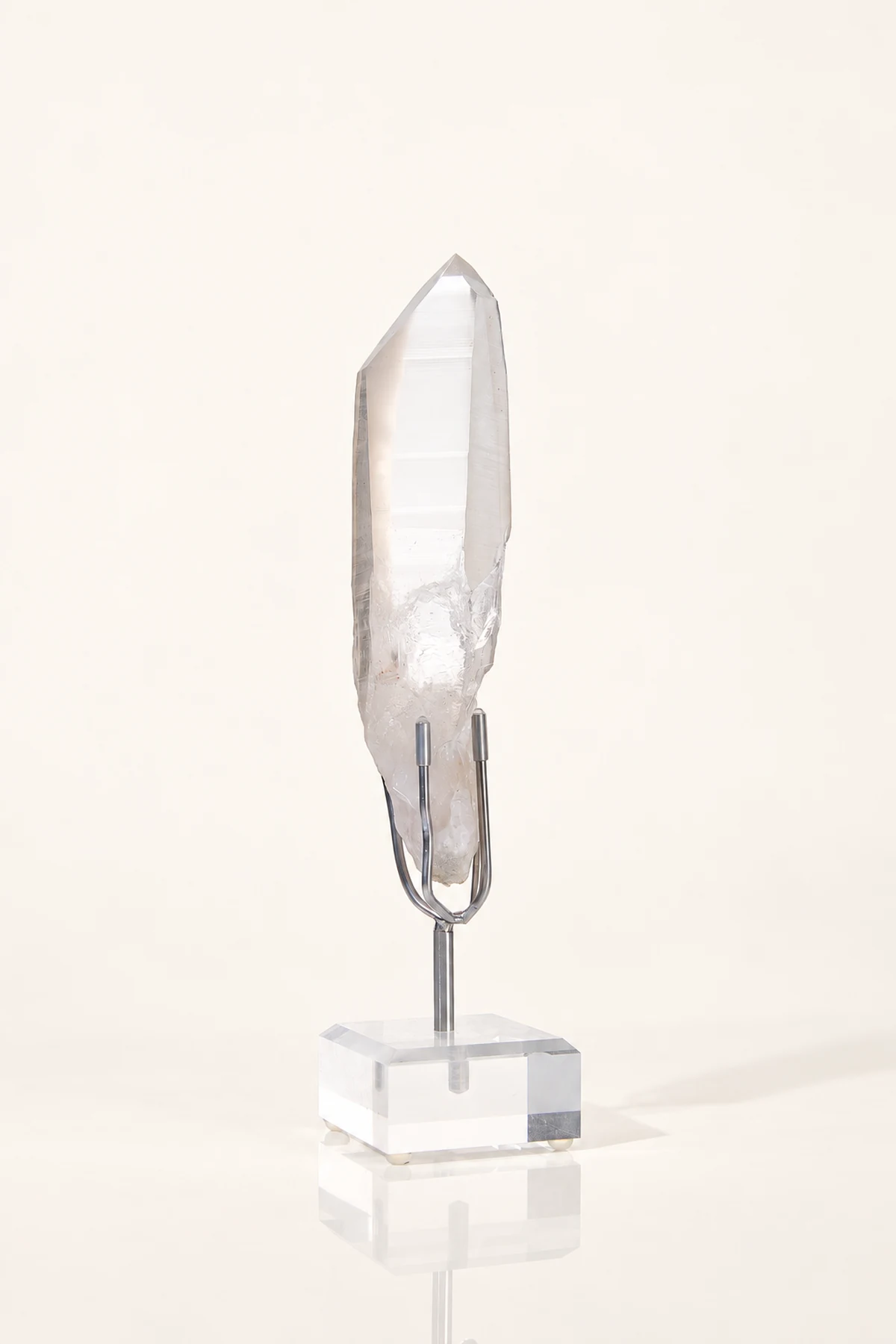 Clear quartz point on a metal stand
